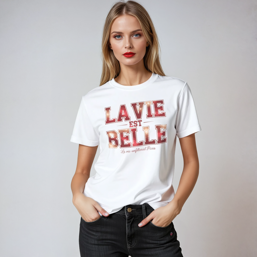 Woman wearing a white t-shirt with 'LA VIE EST BELLE' text on a plain background