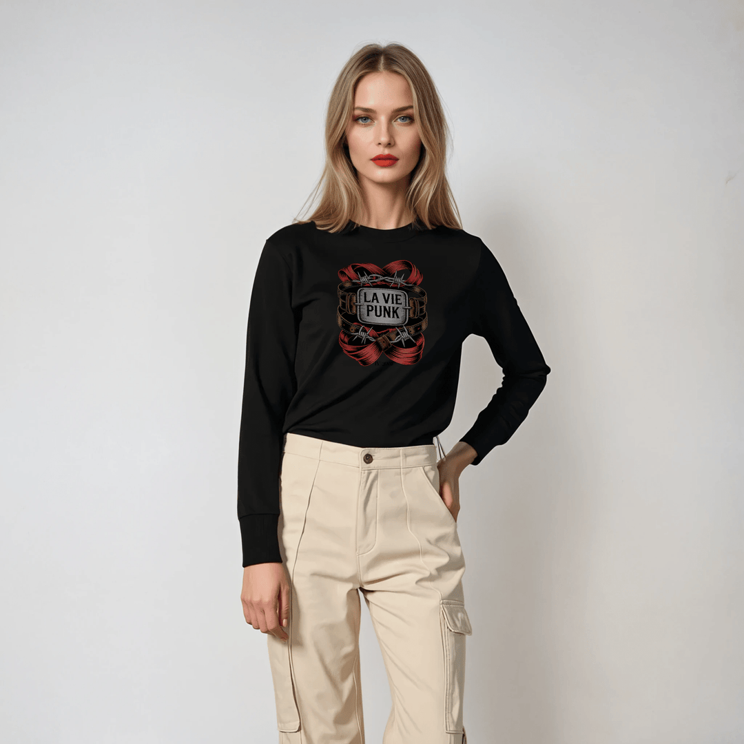 Model in black long-sleeve tee with red chain-inspired La Vie Punk graphic, paired with beige high-waisted cargo trousers in studio setting.