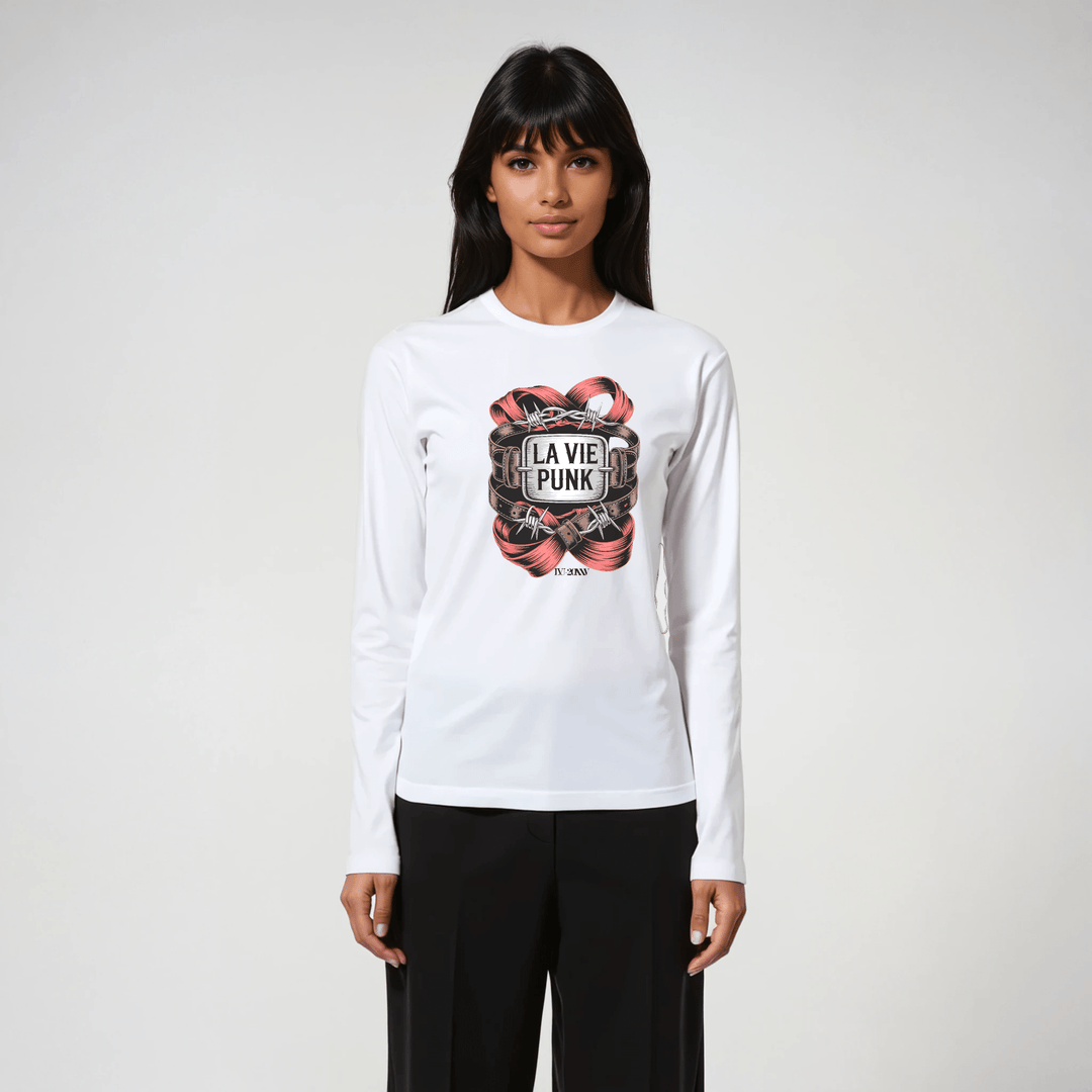 Woman wearing white long-sleeve tee with La Vie Punk Paris in Chains graphic, styled with black tailored pants.